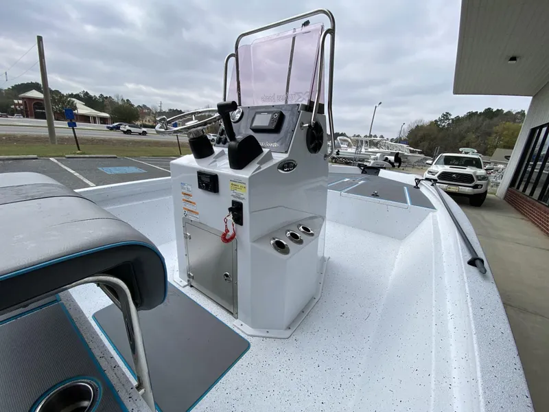 Slide: The Image of 2021 Xpress H190B boat with center console, parked outdoors near a dealership. - 3