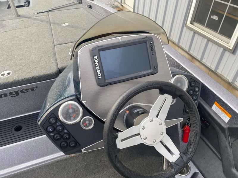 Slide: The Image of 2015 Ranger Z118 Comanche boat dashboard with steering wheel and navigation display. - 8