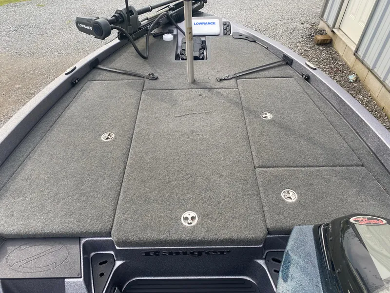 Slide: The Image of 2015 Ranger Z118 Comanche boat deck with Lowrance equipment and carpeted surface. - 9
