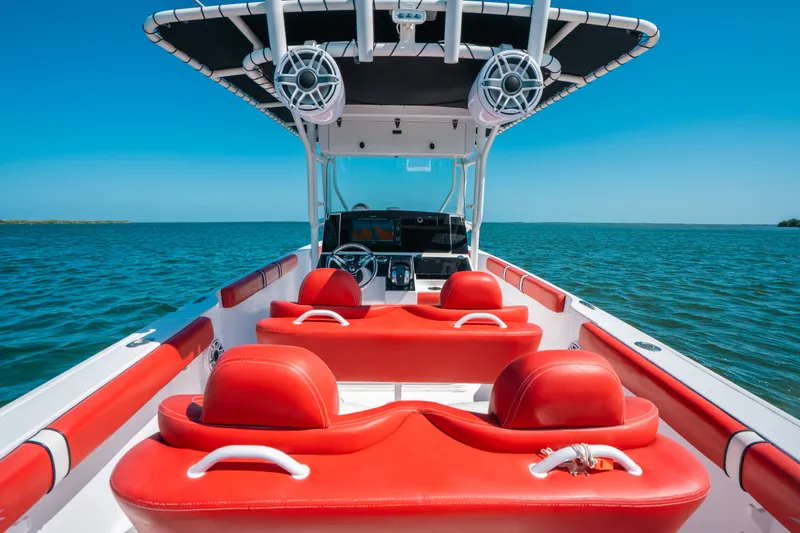 Slide: The Image of 2007 Donzi 38 ZF Cuddy boat with red seating on open water. - 11