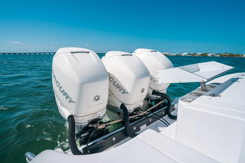 Slide: The Image of 2007 Donzi 38 ZF Cuddy with triple Mercury outboard engines on open water. - 16