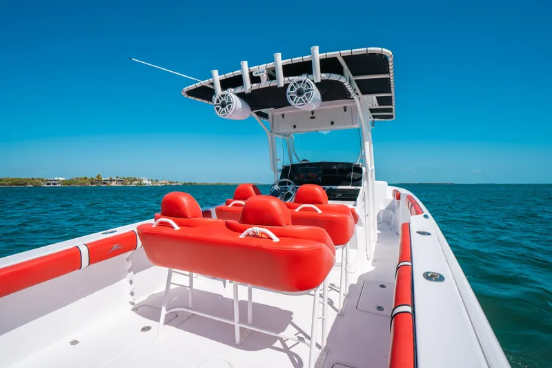 Slide: The Image of 2007 Donzi 38 ZF Cuddy boat with red seating on open water. - 18