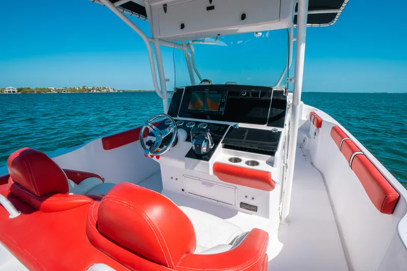 Slide: The Image of 2007 Donzi 38 ZF Cuddy boat interior with red and white seating, ocean view. - 22