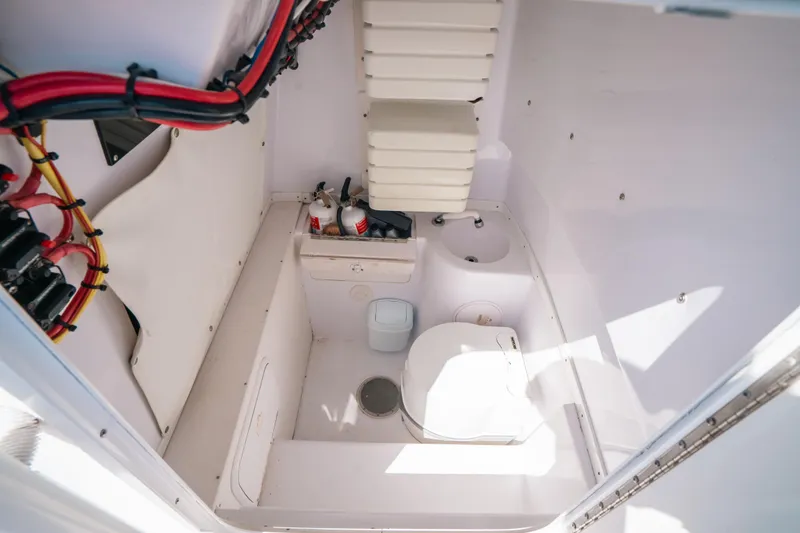 Slide: The Image of 2007 Donzi 38 ZF Cuddy interior with compact marine toilet and storage. - 24