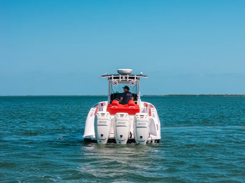 Slide: The Image of 2007 Donzi 38 ZF Cuddy boat with triple engines cruising on open water. - 25