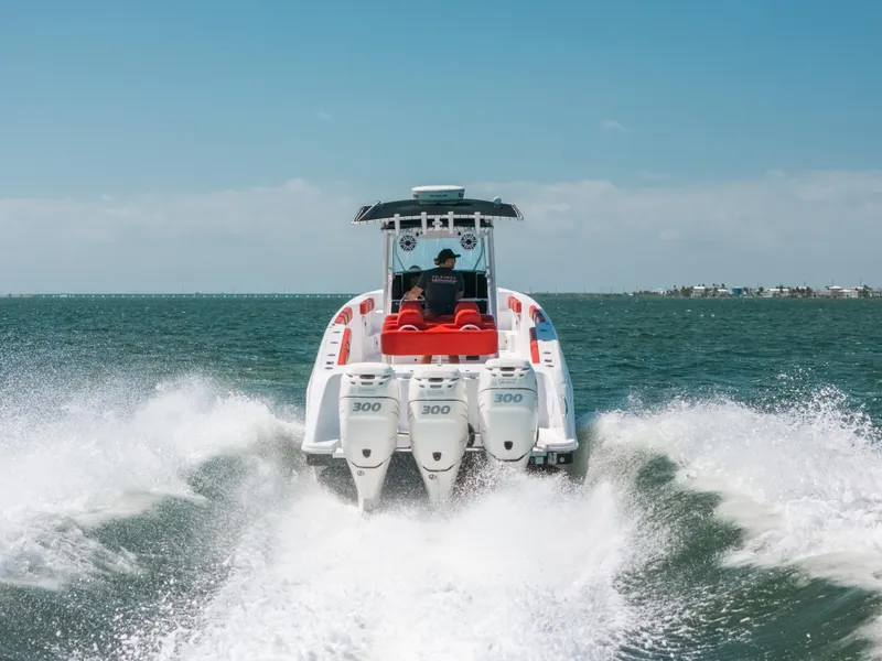 Slide: The Image of 2007 Donzi 38 ZF Cuddy speeding on open water, rear view. - 26