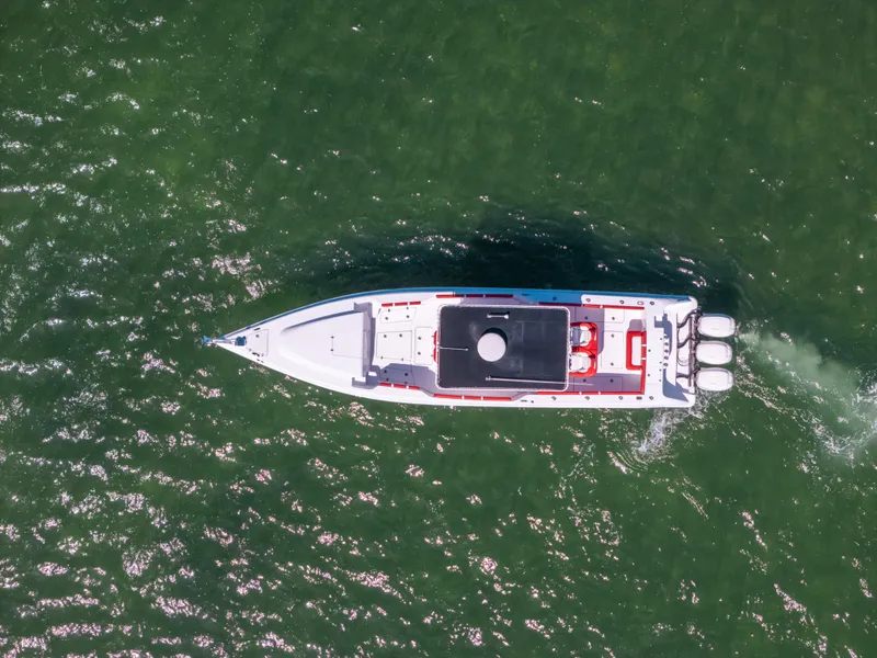 Slide: The Image of Aerial view of 2007 Donzi 38 ZF Cuddy boat cruising on green water. - 27
