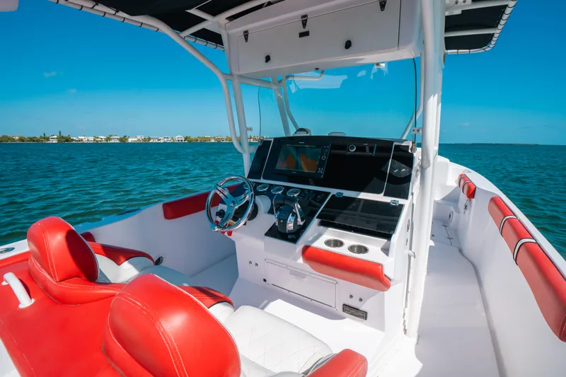 Slide: The Image of 2007 Donzi 38 ZF Cuddy boat interior with red and white seating, ocean view. - 3