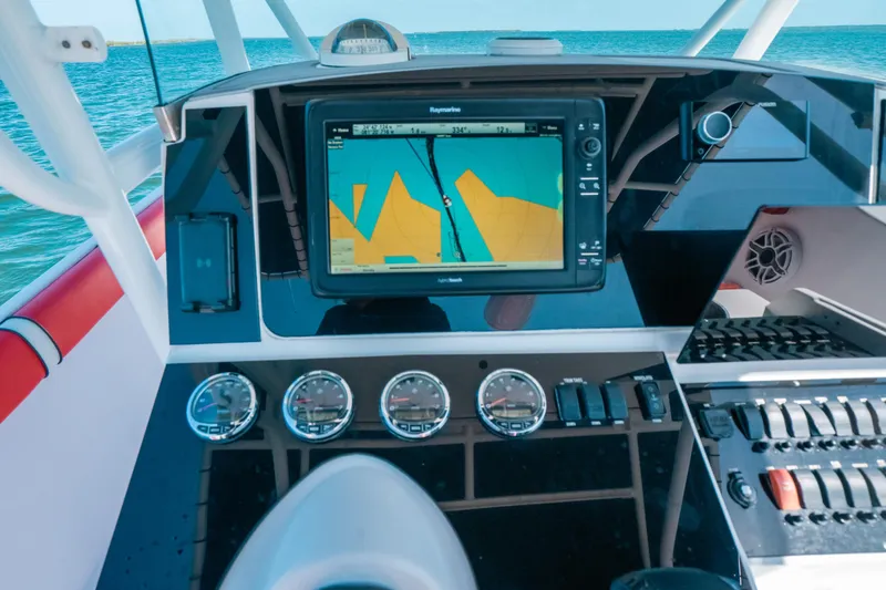 Slide: The Image of Dashboard of a 2007 Donzi 38 ZF Cuddy boat with navigation system and gauges. - 4
