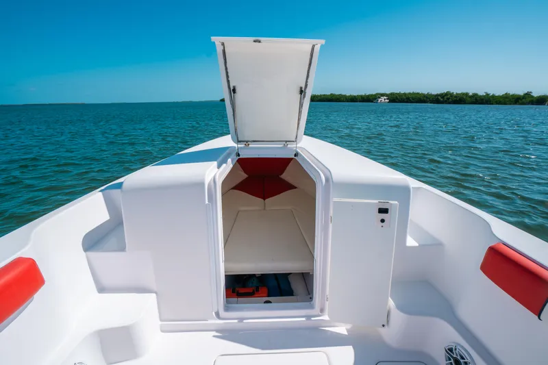Slide: The Image of 2007 Donzi 38 ZF Cuddy boat interior with open hatch, on calm blue water. - 8
