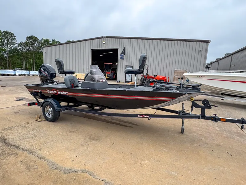 Slide: The Image of 2021 Tracker Bass Tracker Classic XL boat on trailer outside a warehouse. - 11