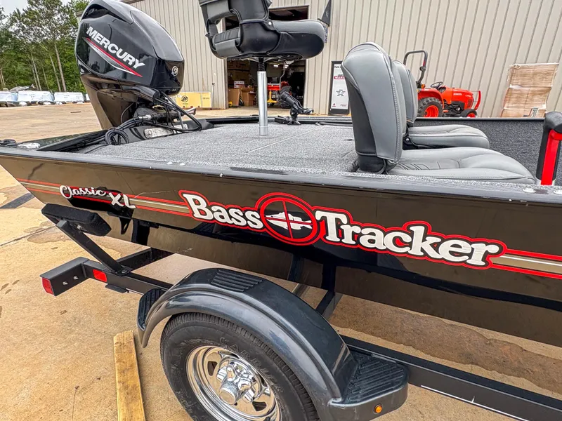 Slide: The Image of 2021 Tracker Bass Tracker Classic XL boat with Mercury engine, parked on a trailer. - 12