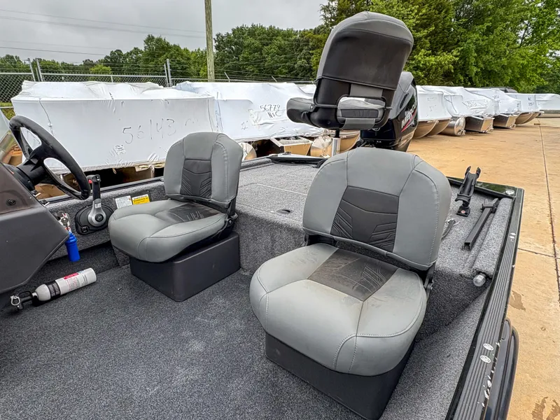 Slide: The Image of 2021 Tracker Bass Tracker Classic XL boat interior with two gray seats and fishing equipment. - 5
