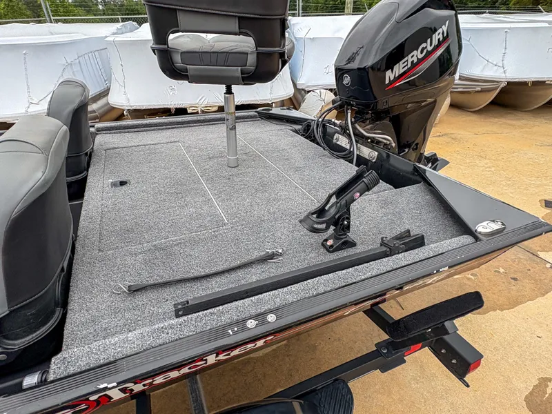 Slide: The Image of 2021 Tracker Bass Tracker Classic XL boat with Mercury engine, featuring a spacious deck. - 6