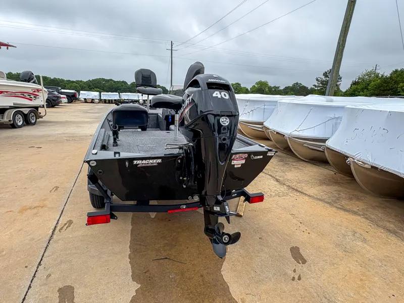 Slide: The Image of 2021 Tracker Bass Tracker Classic XL boat with 40 HP engine, parked outdoors. - 8