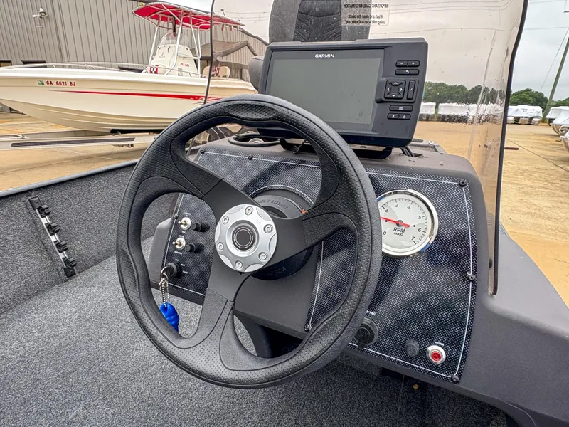 Slide: The Image of 2021 Tracker Bass Tracker Classic XL dashboard with steering wheel and navigation system. - 9
