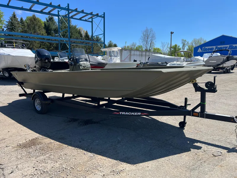Slide: The Image of 2024 Tracker Grizzly 2072 CC boat on trailer in outdoor lot. - 2