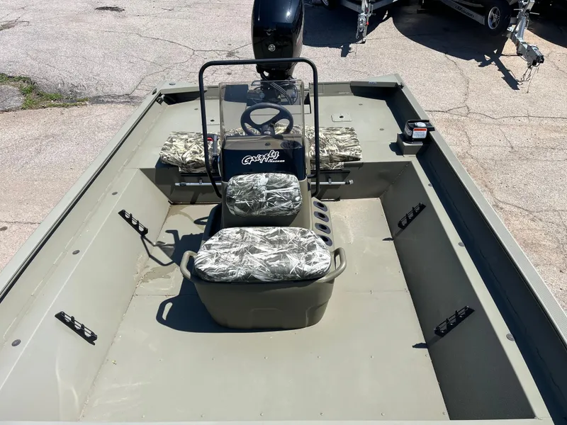 Slide: The Image of 2024 Tracker Grizzly 2072 CC boat interior with camouflage seats and steering console. - 4