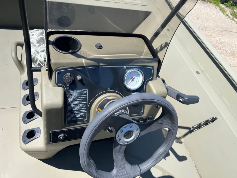 Slide: The Image of 2024 Tracker Grizzly 2072 CC boat console with steering wheel and gauges. - 8