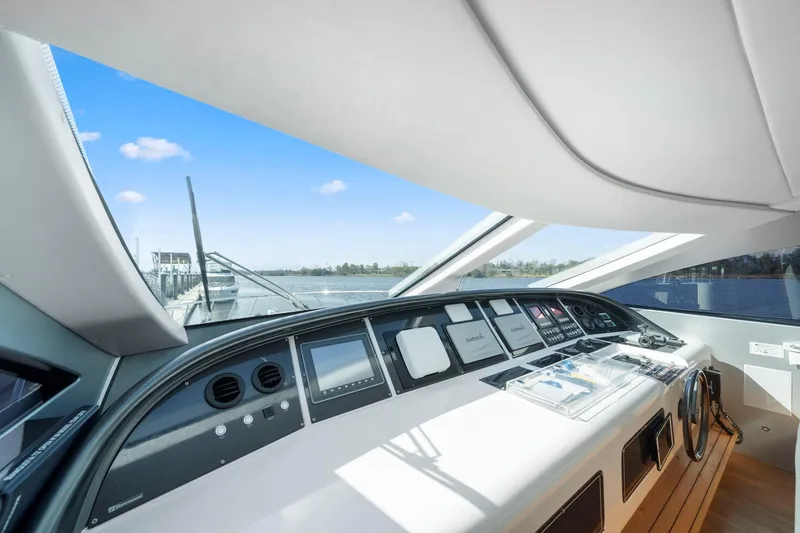 Slide: The Image of 2010 Mangusta 72 Express yacht docked by waterfront construction site. - 11