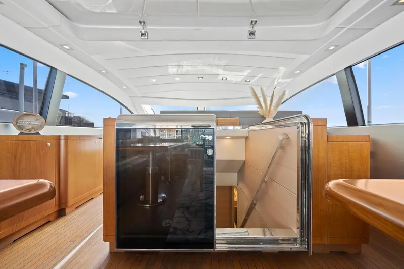 Slide: The Image of Luxurious interior of 2010 Mangusta 72 Express yacht with modern seating and dining area. - 18