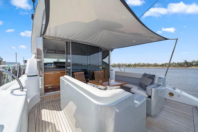 Slide: The Image of Luxury 2010 Mangusta 72 Express yacht docked near modern waterfront buildings. - 3