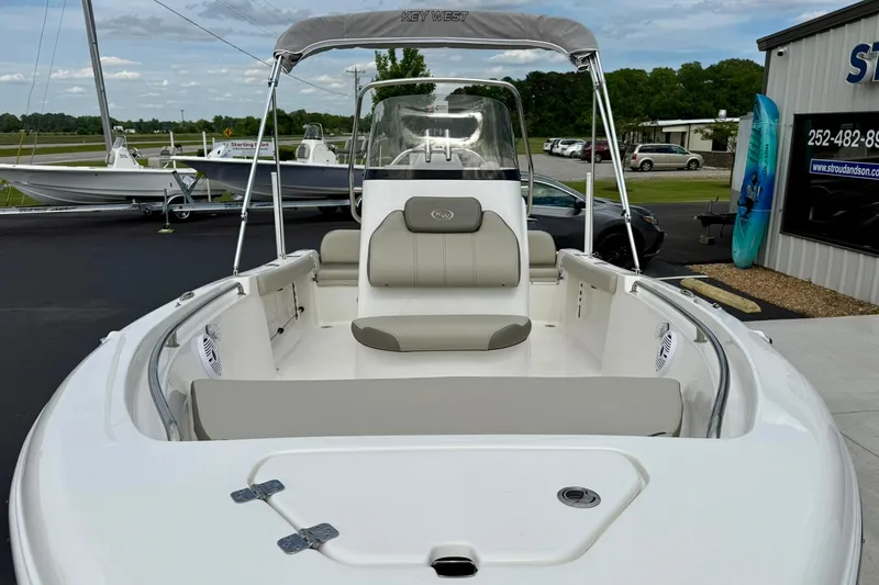 Slide: The Image of 2023 Key West 189 FS boat with seating and canopy, displayed outdoors. - 10