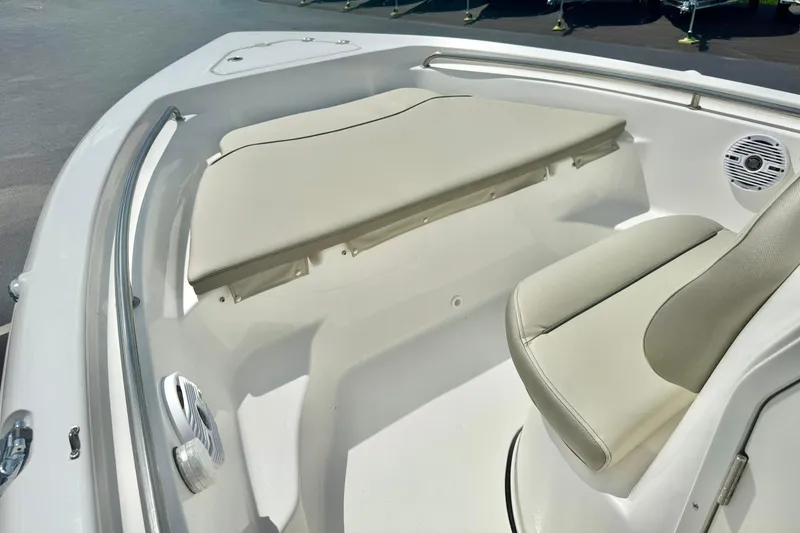 Slide: The Image of 2023 Key West 189 FS boat interior with beige seating and storage. - 11