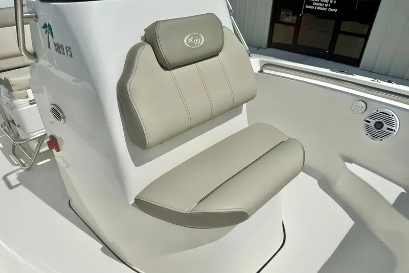 Slide: The Image of 2023 Key West 189 FS boat seat with beige upholstery and console details. - 14
