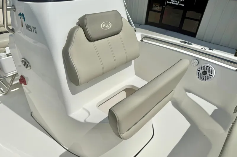 Slide: The Image of 2023 Key West 189 FS boat seat with beige upholstery and console details. - 15