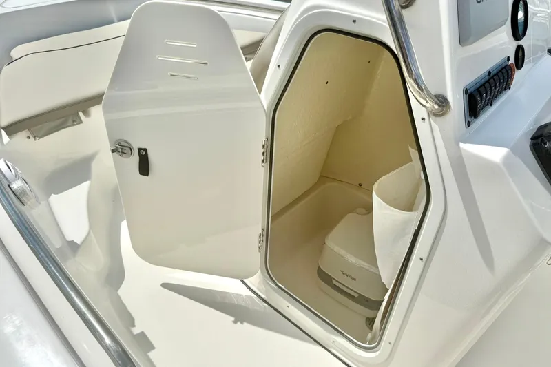 Slide: The Image of 2023 Key West 189 FS boat interior storage compartment with open door. - 20
