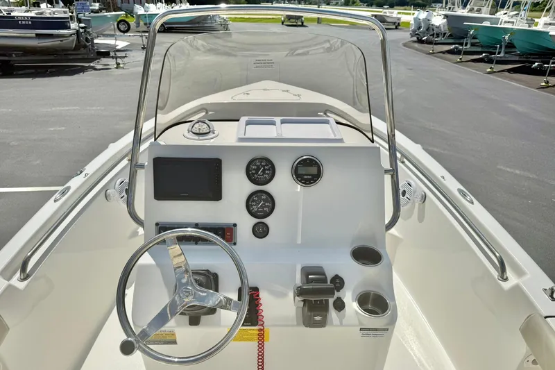 Slide: The Image of 2023 Key West 189 FS boat dashboard with steering wheel and gauges. - 22