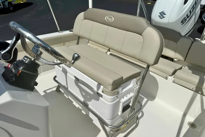 Slide: The Image of 2023 Key West 189 FS boat interior with steering wheel and cushioned seating. - 24