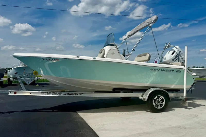 Slide: The Image of 2023 Key West 189 FS boat on trailer under blue sky. - 4