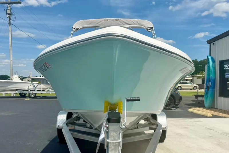 Slide: The Image of 2023 Key West 189 FS boat on trailer, front view under clear blue sky. - 7