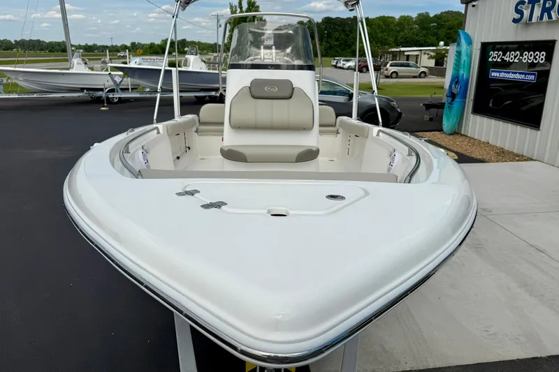 Slide: The Image of 2023 Key West 189 FS boat, white exterior, displayed outdoors at a dealership. - 9