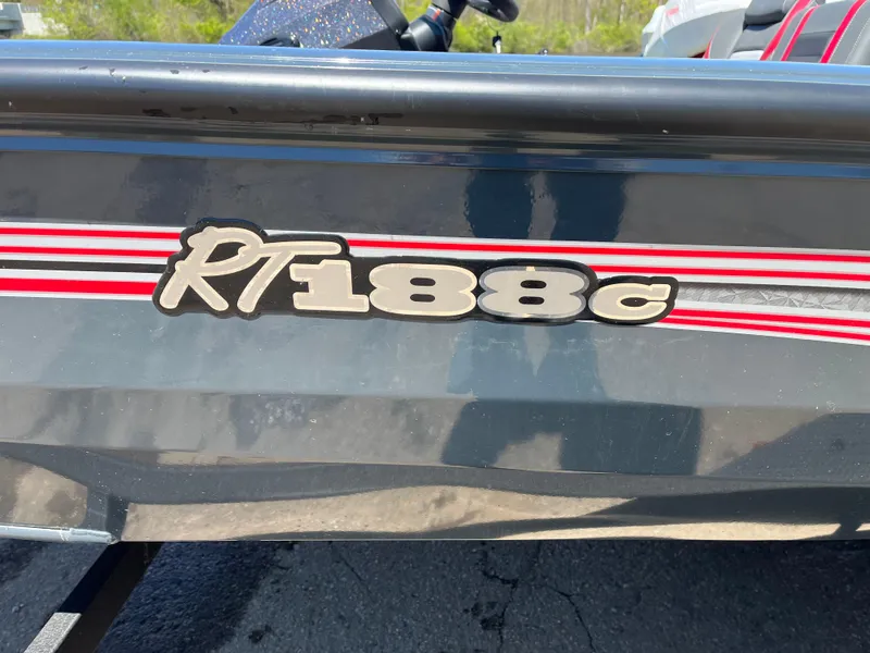 Slide: The Image of 2024 Ranger RT188C boat with red and white stripes on a black hull. - 12