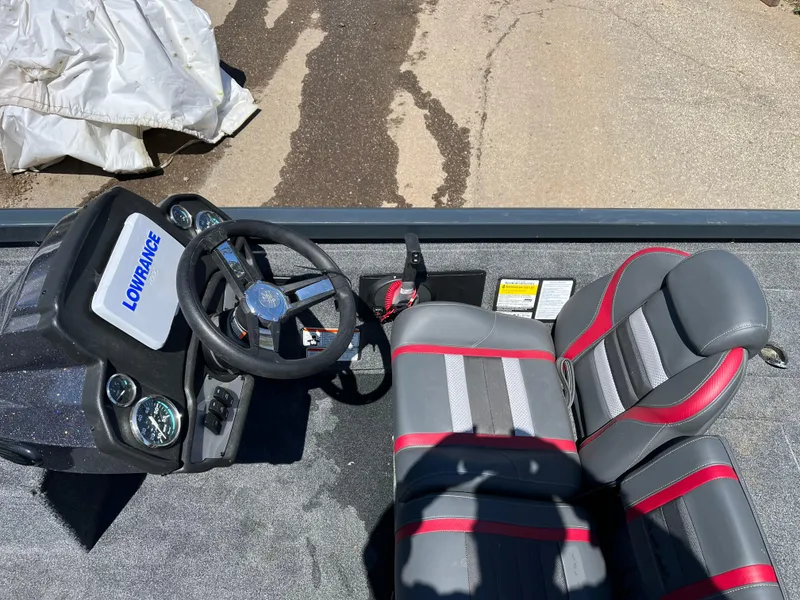Slide: The Image of 2024 Ranger RT188C boat interior with steering wheel and seats, featuring Lowrance electronics. - 7