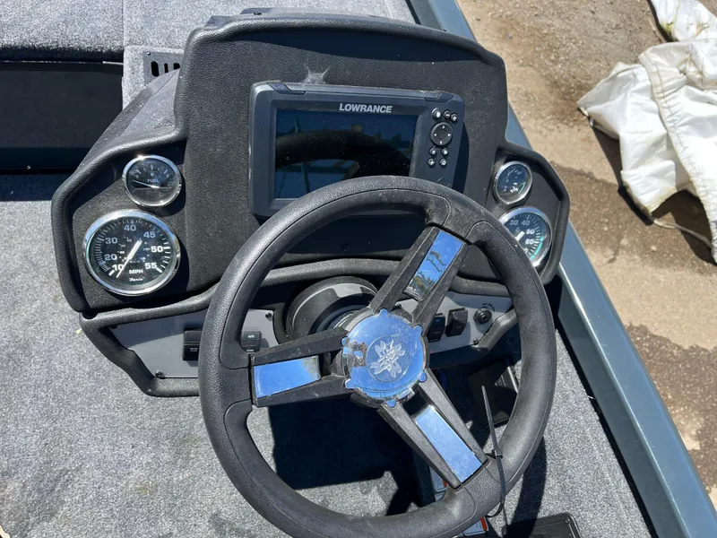 Slide: The Image of 2024 Ranger RT188C boat dashboard with Lowrance display and steering wheel. - 8