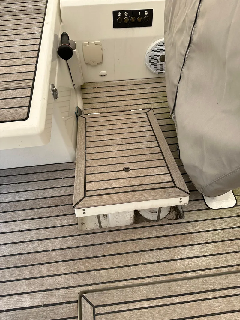 Slide: The Image of Teak deck of 2020 Beneteau Oceanis 51.1 sailboat, featuring a covered step and control panel. - 10