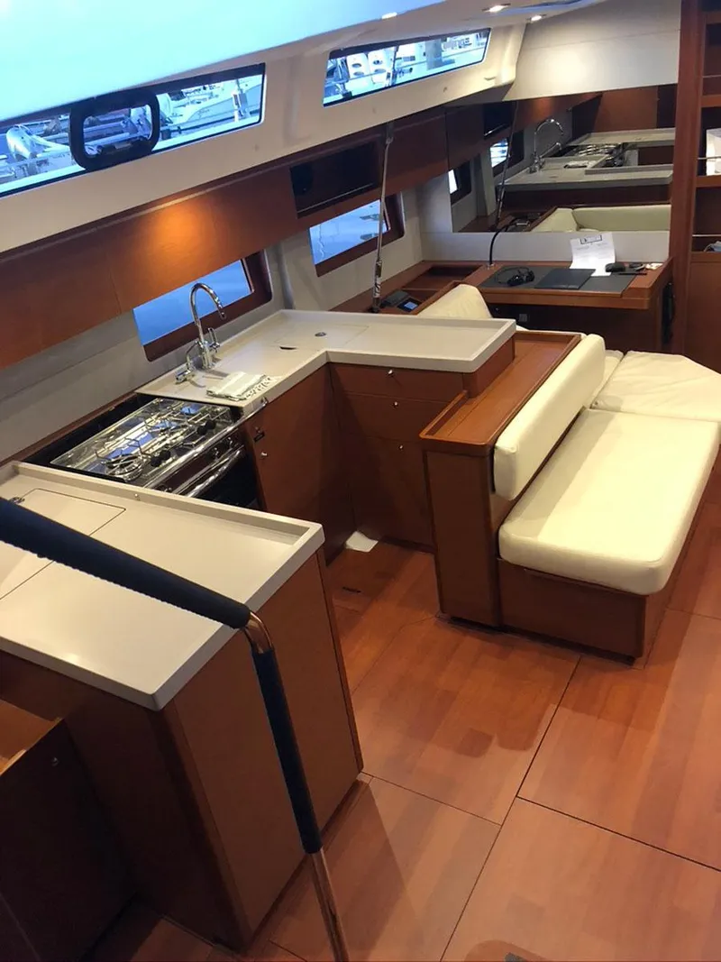 Slide: The Image of Interior of 2020 Beneteau Oceanis 51.1 yacht with modern kitchen and seating area. - 16