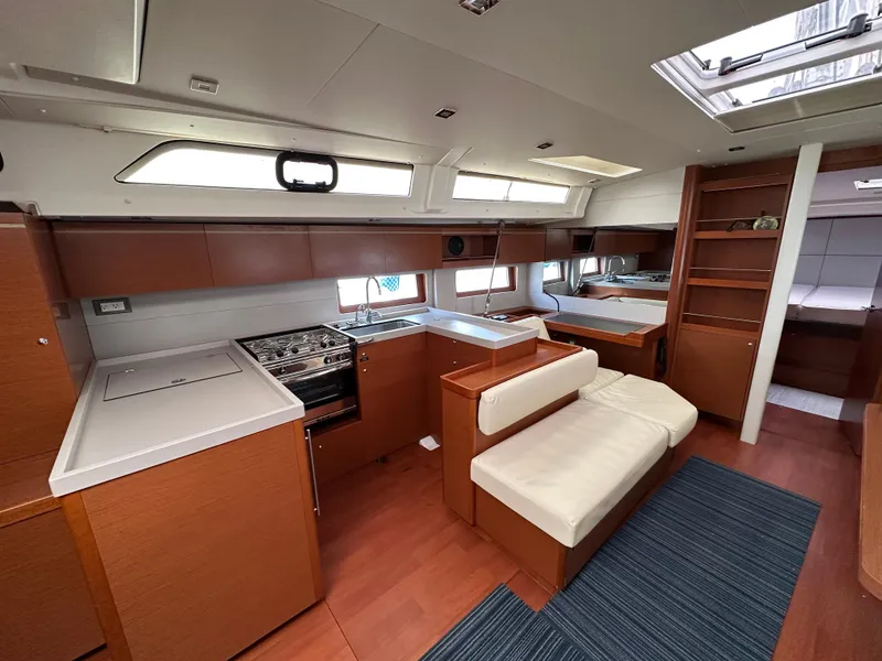 Slide: The Image of Interior of 2020 Beneteau Oceanis 51.1 yacht, featuring modern kitchen and seating area. - 17