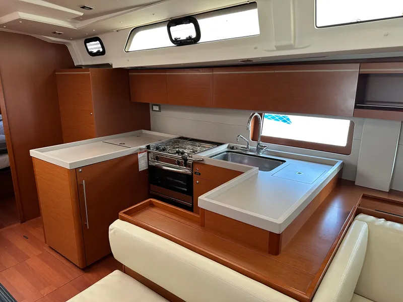 Slide: The Image of Modern kitchen interior of 2020 Beneteau Oceanis 51.1 yacht with wood finish and appliances. - 18