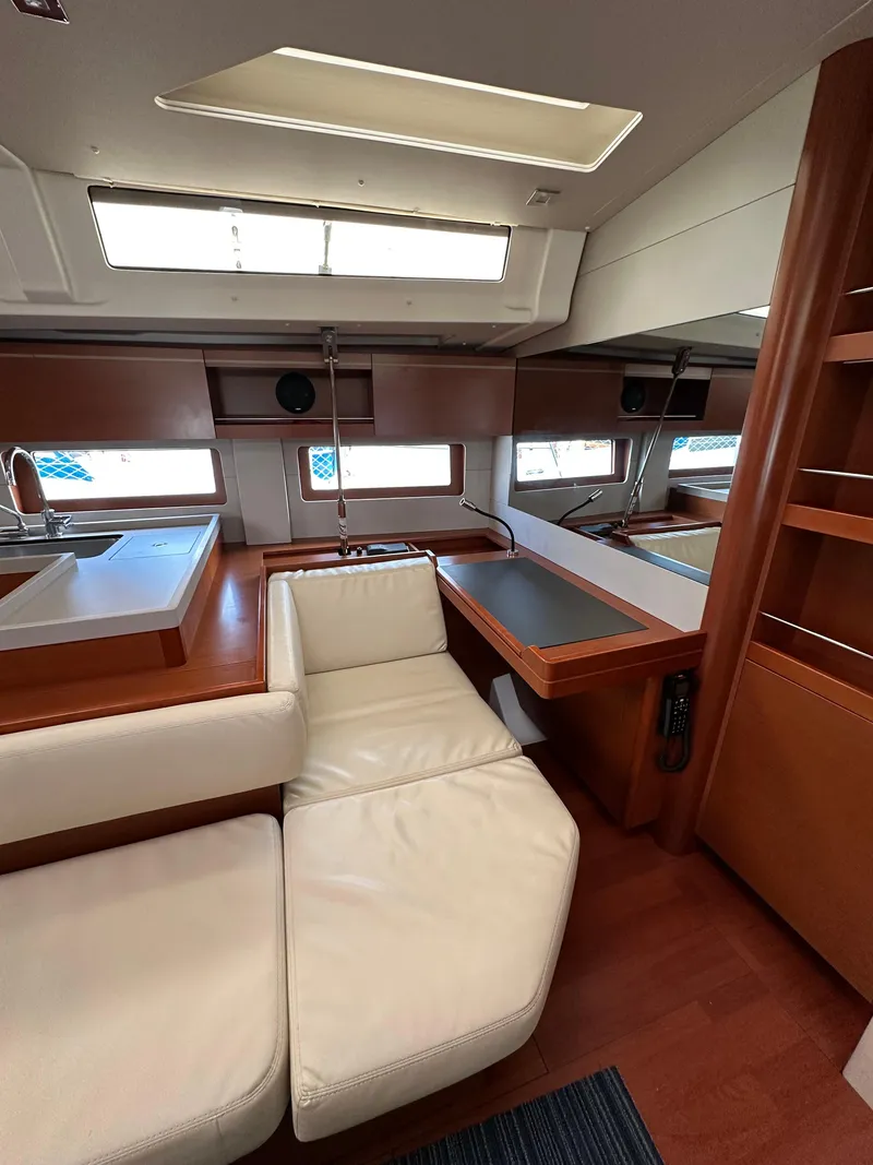 Slide: The Image of Interior of 2020 Beneteau Oceanis 51.1 yacht with modern seating and wooden finishes. - 28