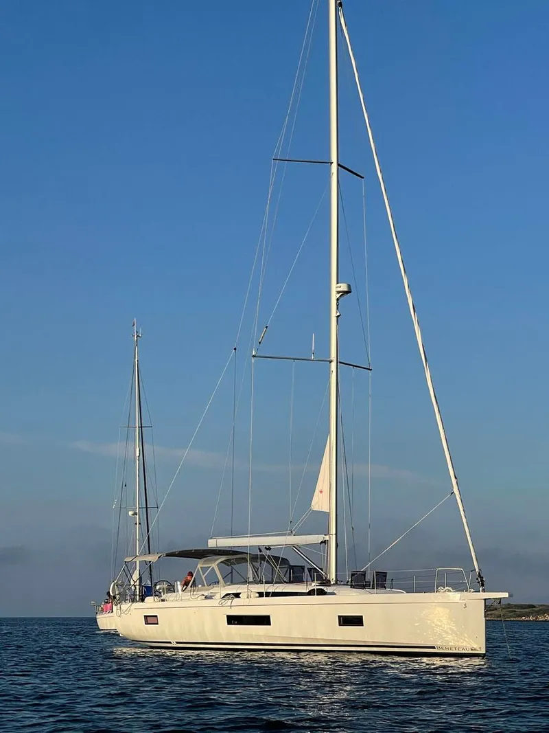 Slide: The Image of 2020 Beneteau Oceanis 51.1 sailboat on calm sea under clear blue sky. - 3