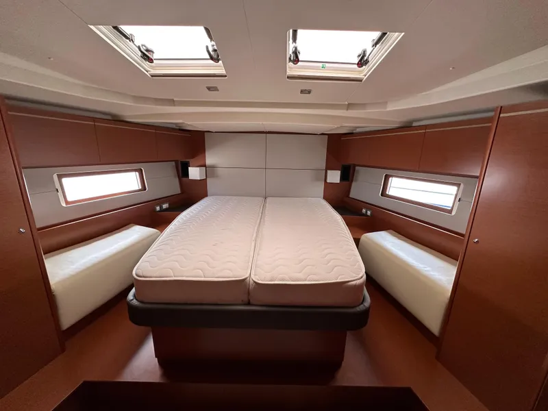 Slide: The Image of Luxurious cabin interior of 2020 Beneteau Oceanis 51.1 yacht with skylights and twin beds. - 31