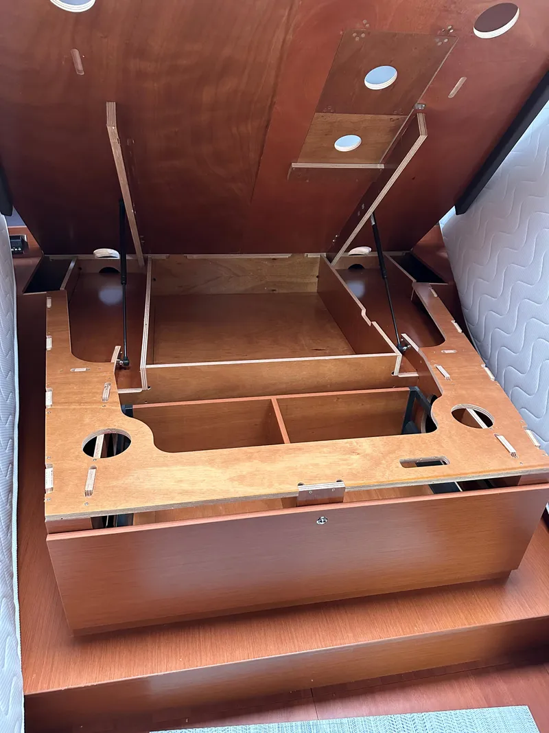 Slide: The Image of Interior view of 2020 Beneteau Oceanis 51.1 yacht, showcasing wooden storage compartment. - 34