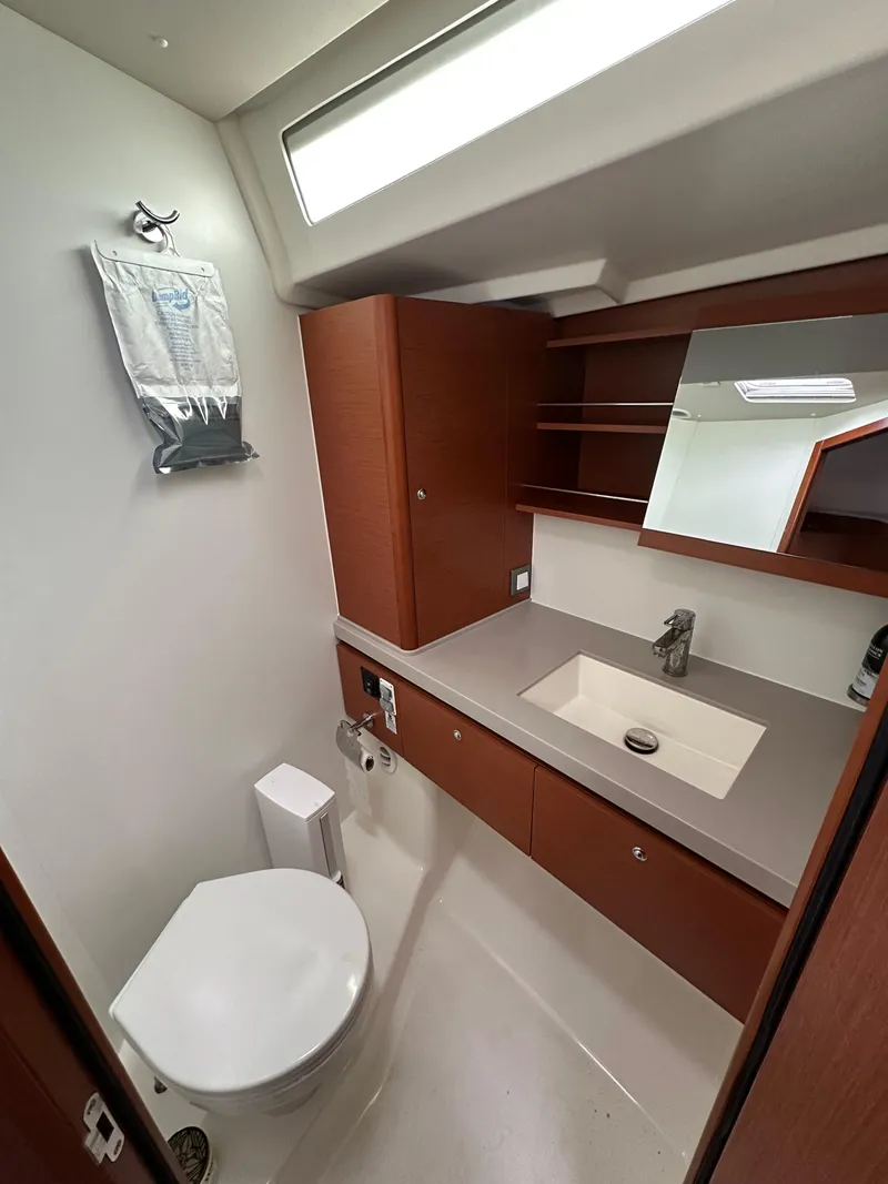 Slide: The Image of Modern bathroom in 2020 Beneteau Oceanis 51.1 yacht with sleek fixtures and wood cabinetry. - 36