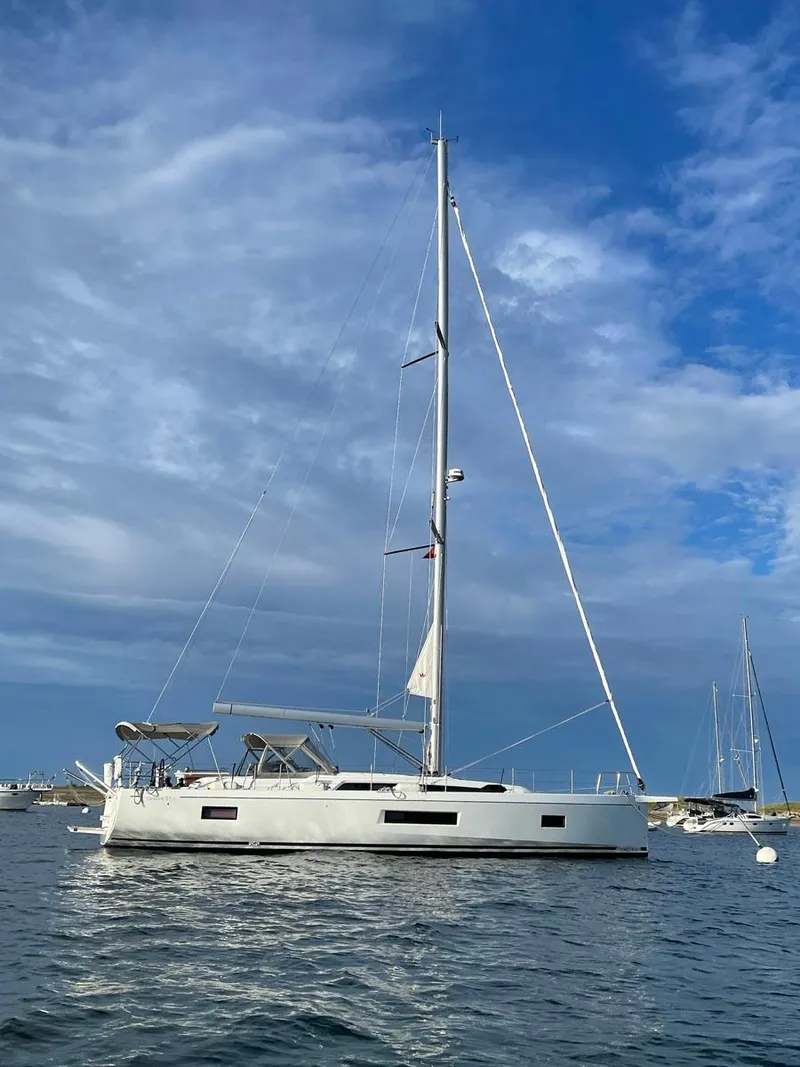 Slide: The Image of 2020 Beneteau Oceanis 51.1 sailboat on calm water under a blue sky. - 4