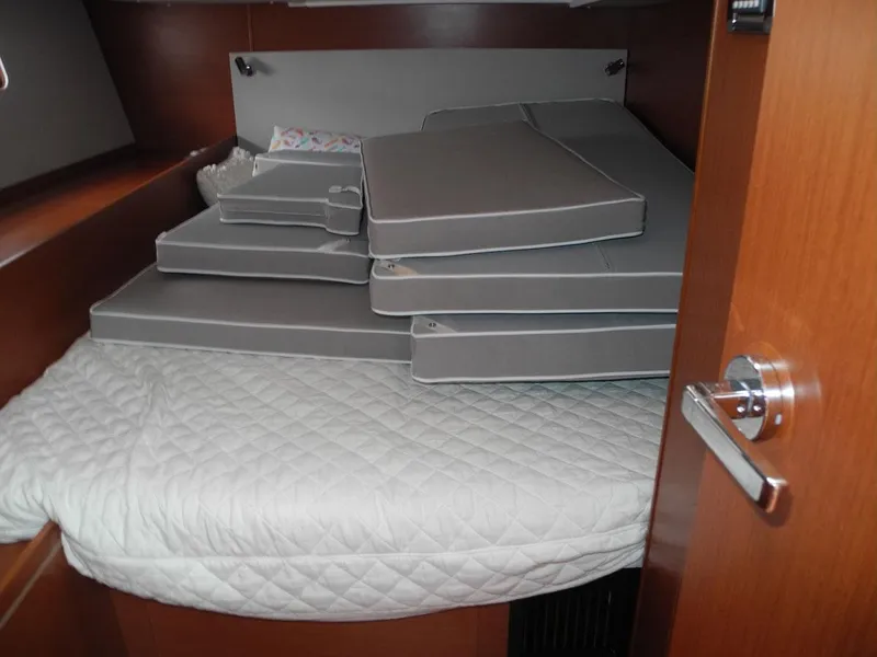 Slide: The Image of Cabin interior of 2020 Beneteau Oceanis 51.1 with stacked cushions on bed. - 40